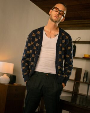 A man wearing glasses and The Castello Cardigan - Abyss by Dandy Del Mar.