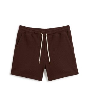 A pair of Dandy Del Mar's The Cannes Waffle Knit Shorts in Carajillo with an elastic waistband and side pockets, laid flat against a white background.