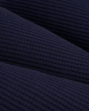 Close-up of the Luxe Navy textured fabric in The Cannes Long Sleeve Shirt by Dandy Del Mar, displaying a subtle grid pattern typical of waffle knit fabric.