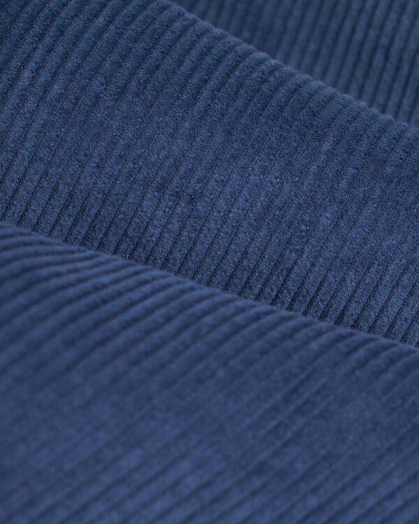 Close-up of folded Moontide 8-wale corduroy fabric from Dandy Del Mar's Corsica Corduroy Shirt, showcasing the ribbed texture and soft material typical of a tailored relaxed fit.