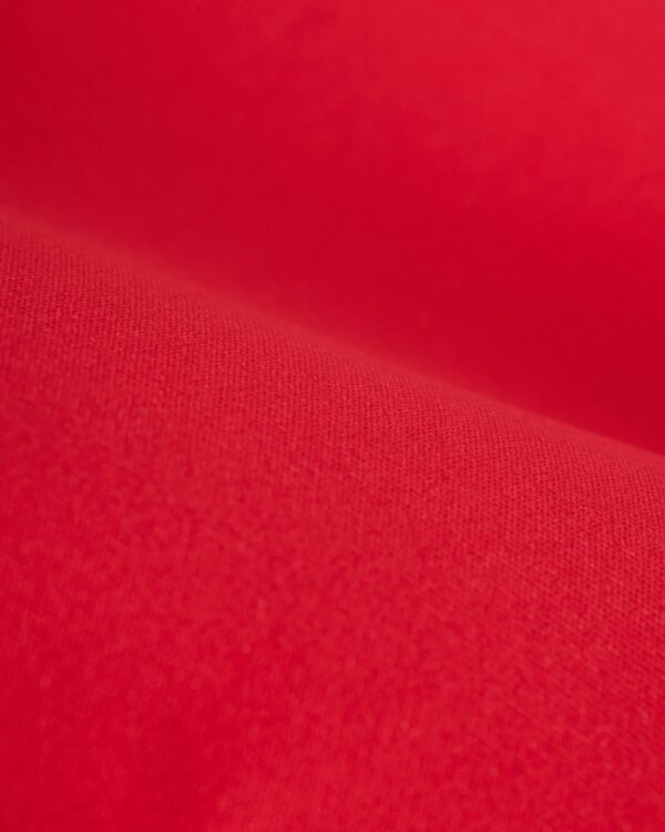 Close-up of the The Deia One Piece - Pico from our women's swim collection, featuring red fabric with a smooth texture, fine weave details, and soft lighting that highlights its high-cut cheeky design.
